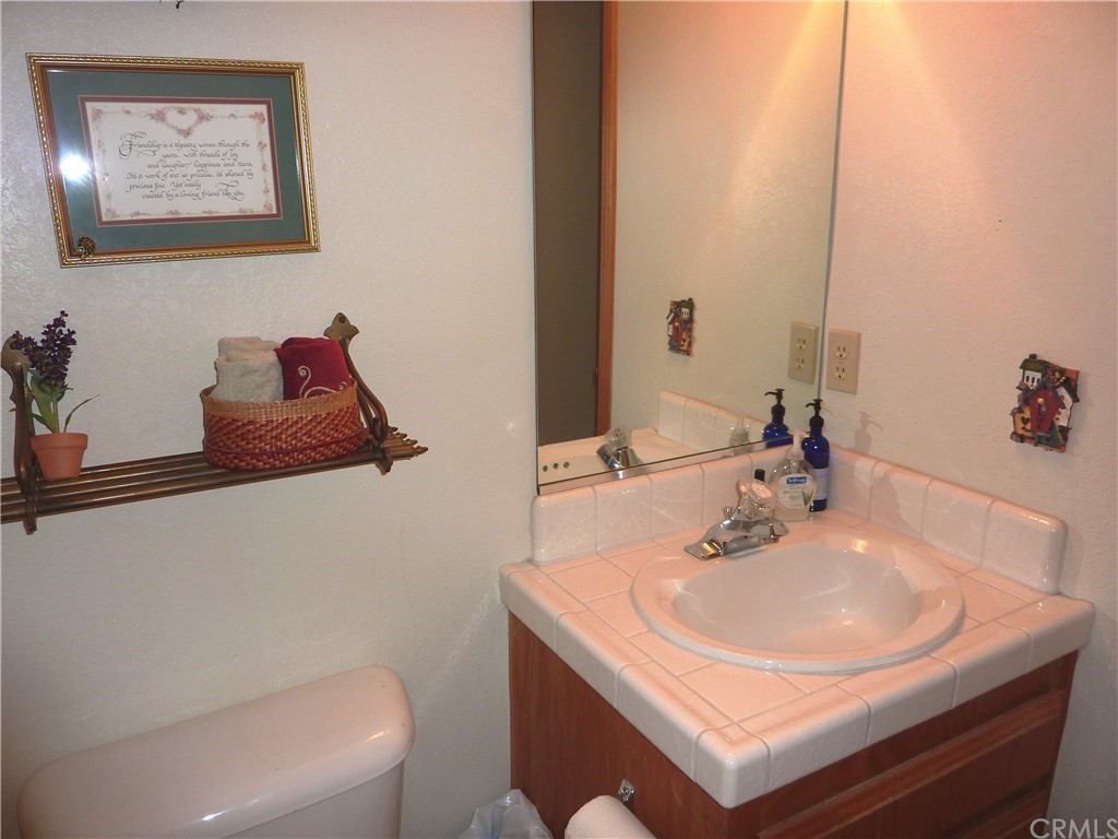 25274 N Road Twin Peaks, CA 92391 - Photo 28 of 35 a bathroom with a sink and a mirror