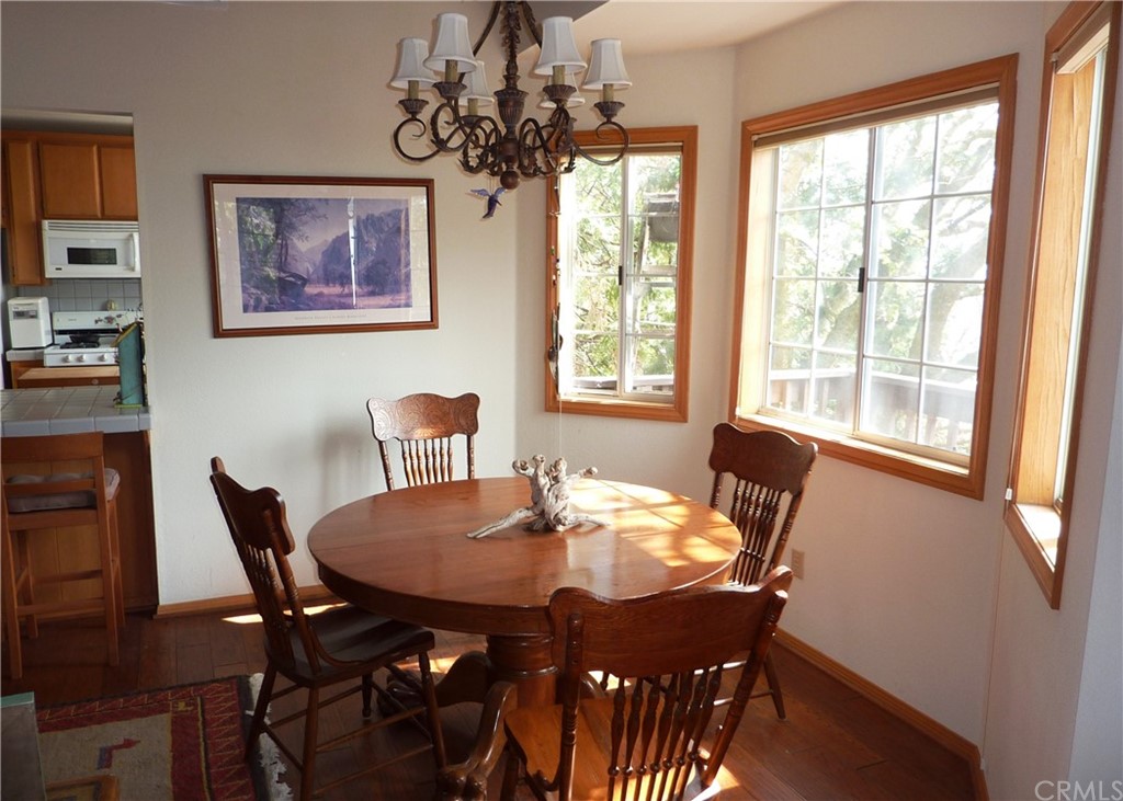 25274 N Road Twin Peaks, CA 92391 - Photo 7 of 35 a view of a dining room with furniture window and outside view