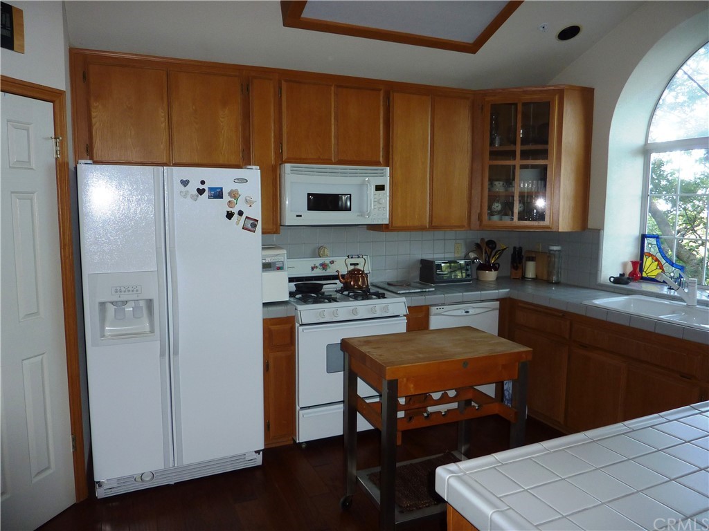 25274 N Road Twin Peaks, CA 92391 - Photo 10 of 35 a kitchen with stainless steel appliances a refrigerator and a stove top oven