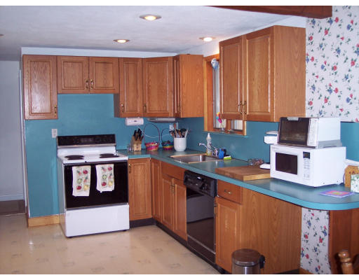 8 Waring Road Natick, MA 01760 - Photo 3 of 4 a kitchen with stainless steel appliances granite countertop a refrigerator sink and cabinets