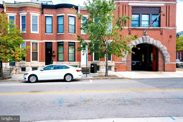 a view of building with parking space in front of it
