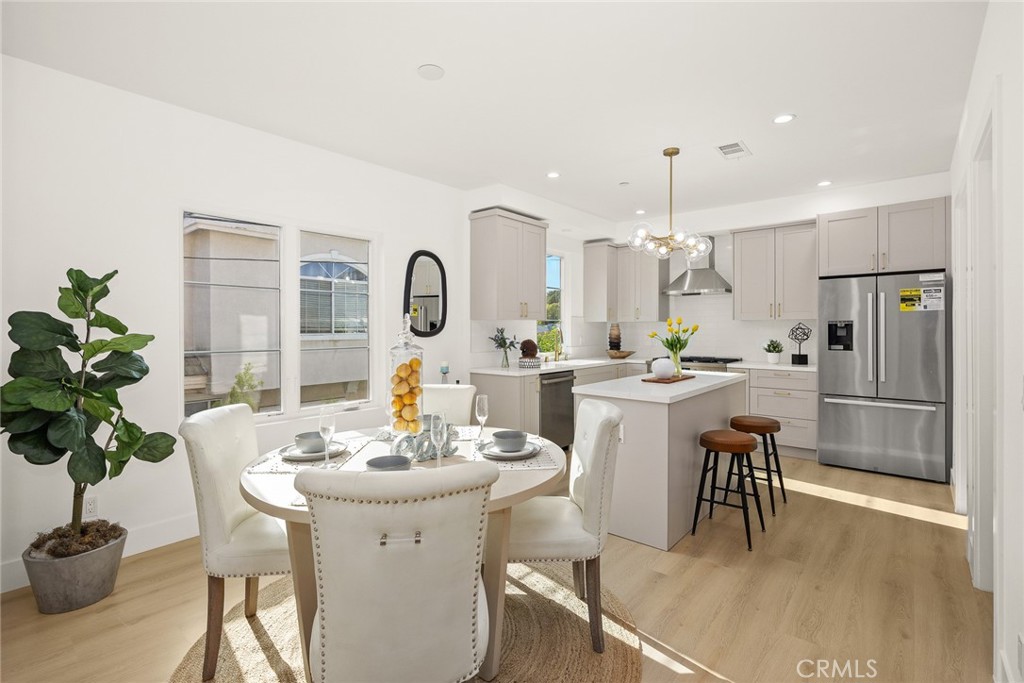 905 Sunset Boulevard, Unit A Arcadia, CA 91007 - Photo 8 of 35 a kitchen with a dining table chairs and refrigerator