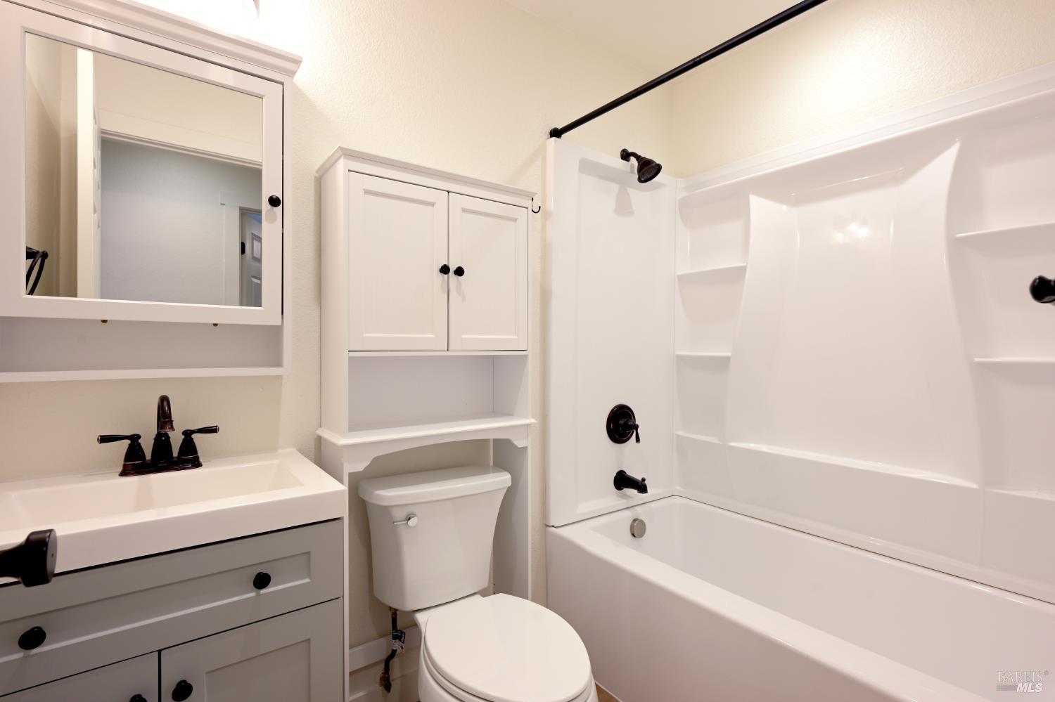 1536 Marlow Road Santa Rosa, CA 95401 - Photo 16 of 21 a bathroom with a sink a mirror a toilet and bathtub