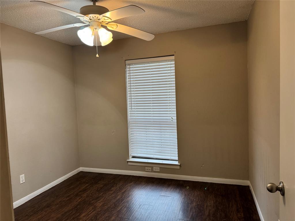 116 Ridge Crest Street Red Oak, TX 75154 - Photo 11 of 18 an empty room with wooden floor chandelier fan and window