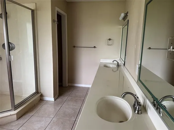 a utility room with shower and mirror