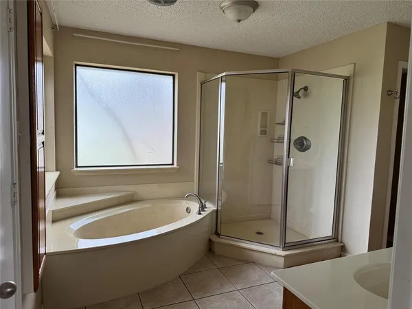 a bathroom with a tub and shower