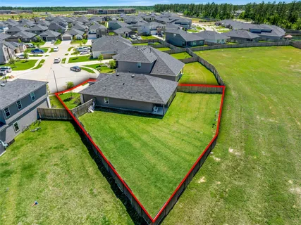 an aerial view of residential houses with outdoor space and swimming pool