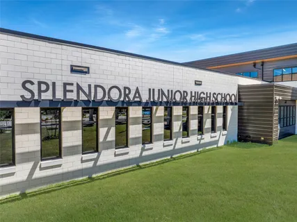 a sign that is sitting in front of flowers