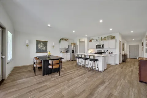 a open kitchen with white cabinets and stainless steel appliances
