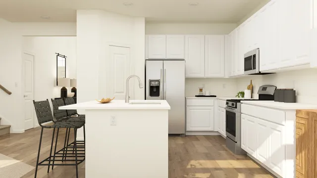 a kitchen with a sink cabinets and appliances