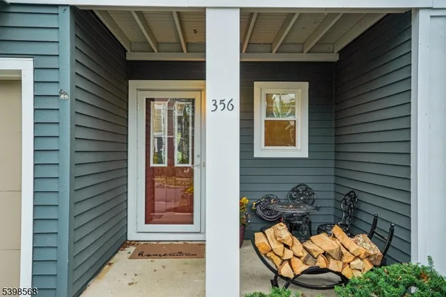 a bathroom with a granite countertop toilet a sink and a mirror