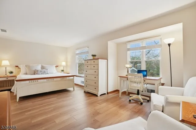 a spacious bedroom with a bed and a window