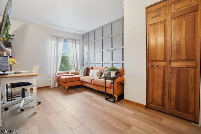 a hallway with painting and a table with wooden floor