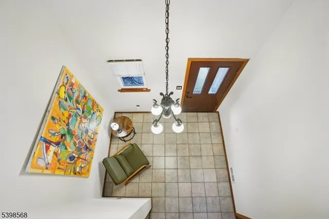 a kitchen with stainless steel appliances a sink dishwasher a refrigerator and cabinets with wooden floor