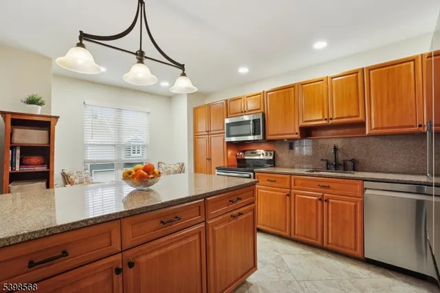 a kitchen with stainless steel appliances a refrigerator and microwave