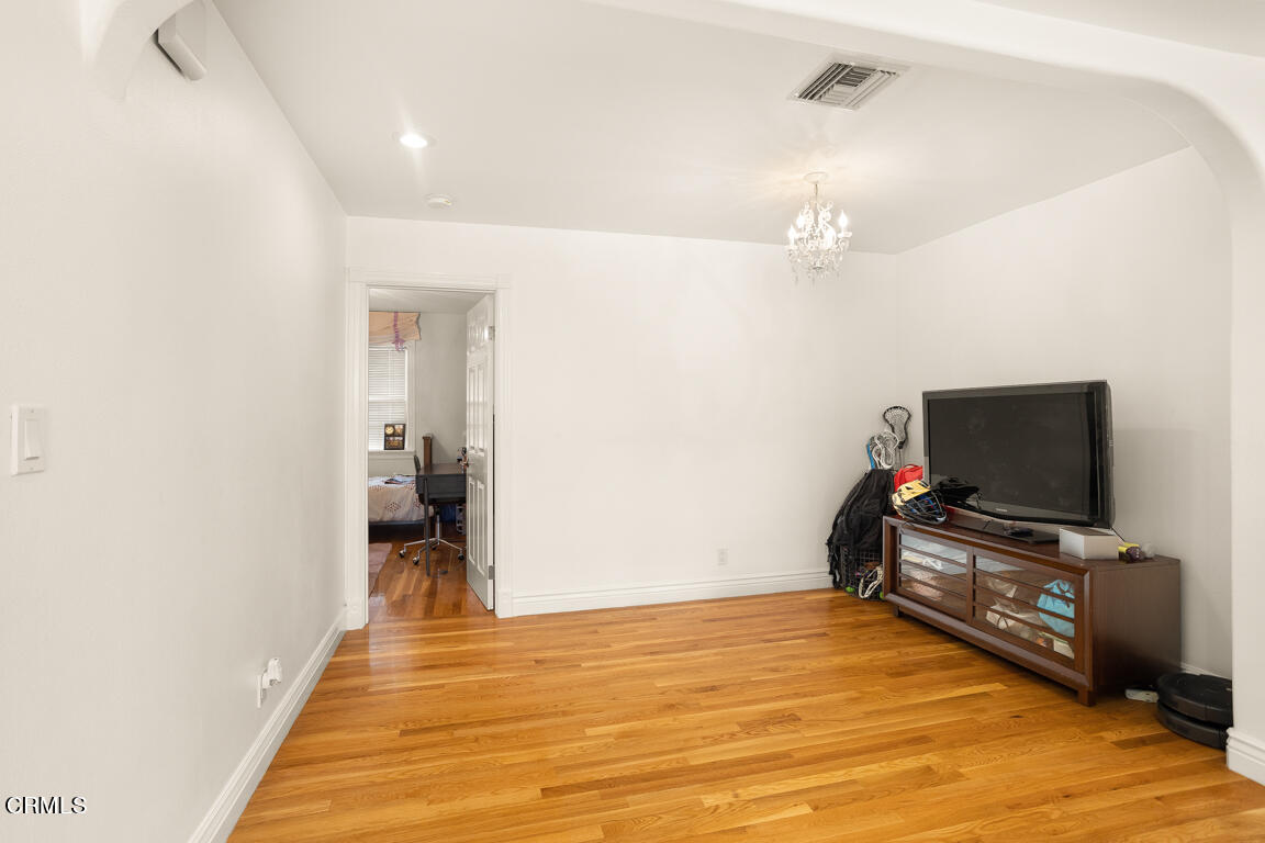 4900 Crown Avenue La Canada Flintridge, CA 91011 - Photo 20 of 41 a view of a livingroom with wooden floor and a flat screen tv