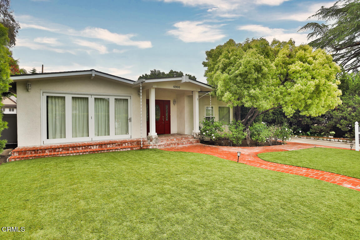 4900 Crown Avenue La Canada Flintridge, CA 91011 - Photo 2 of 41 a view of a white house with a big yard and large trees