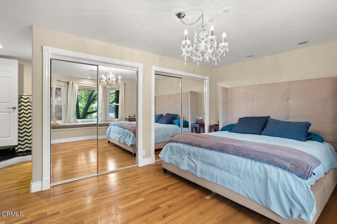 4900 Crown Avenue La Canada Flintridge, CA 91011 - Photo 22 of 41 a spacious bedroom with a balcony a bed and a chandelier