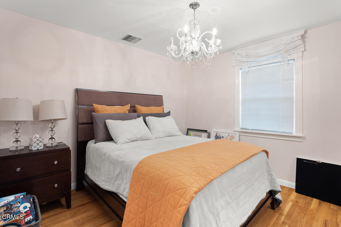 4900 Crown Avenue La Canada Flintridge, CA 91011 - Photo 25 of 41 a bedroom with bed and window with wooden floor