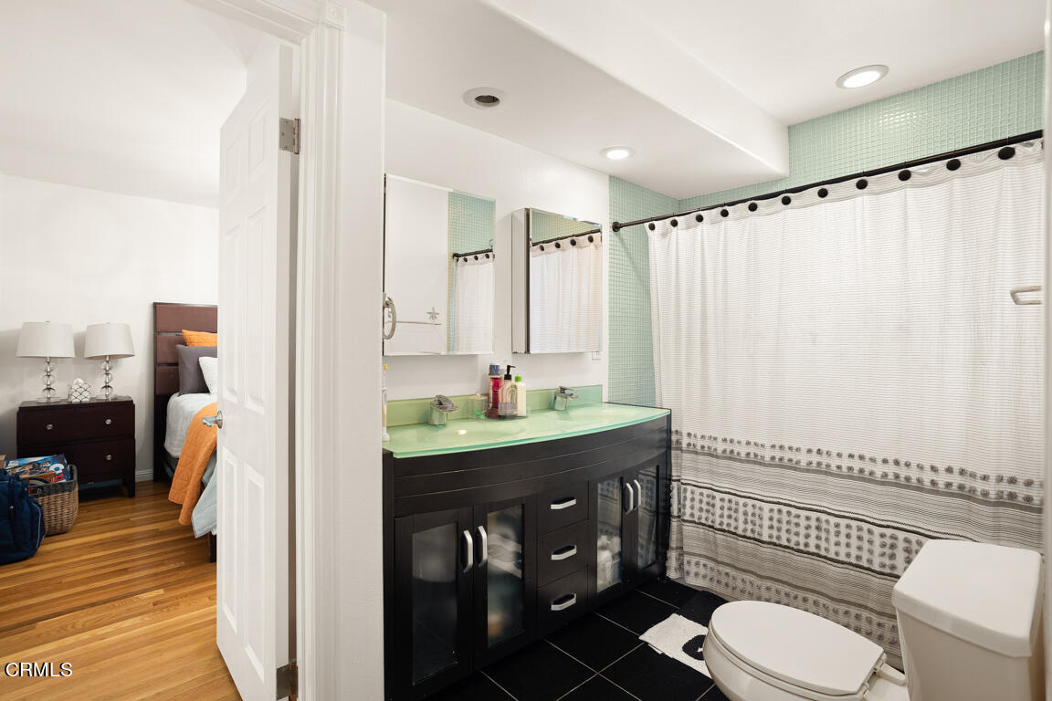 4900 Crown Avenue La Canada Flintridge, CA 91011 - Photo 27 of 41 a bathroom with a granite countertop sink mirror vanity and toilet