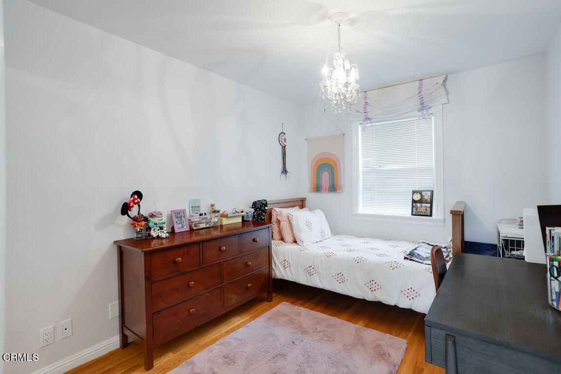 4900 Crown Avenue La Canada Flintridge, CA 91011 - Photo 31 of 41 a bed room with a bed and a chandelier