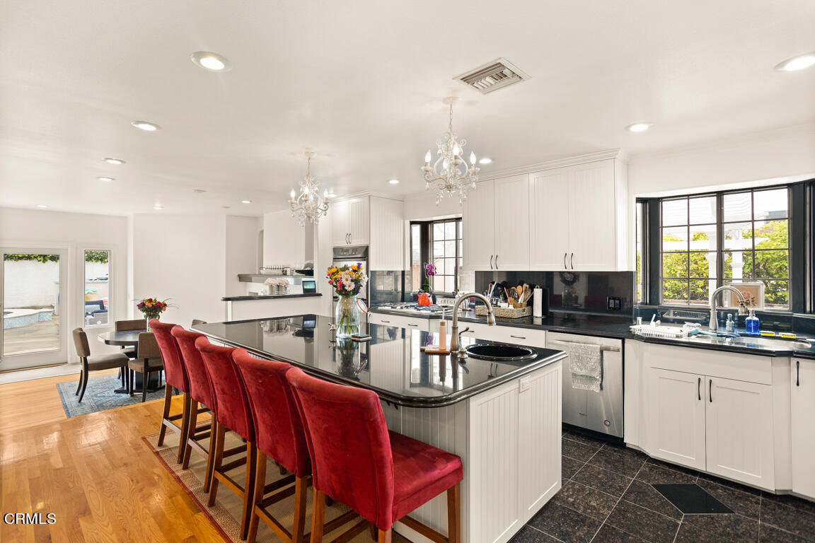 4900 Crown Avenue La Canada Flintridge, CA 91011 - Photo 9 of 41 a kitchen with stainless steel appliances granite countertop a sink a stove a dining table and chairs
