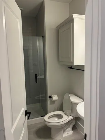 a white toilet sitting next to a bathroom sink