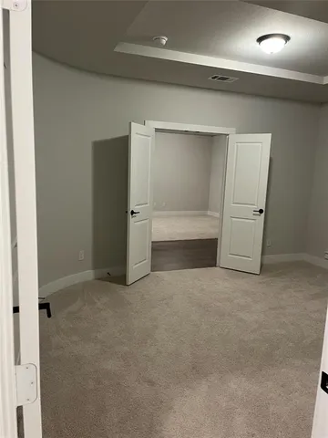 an empty room with closet and cabinet