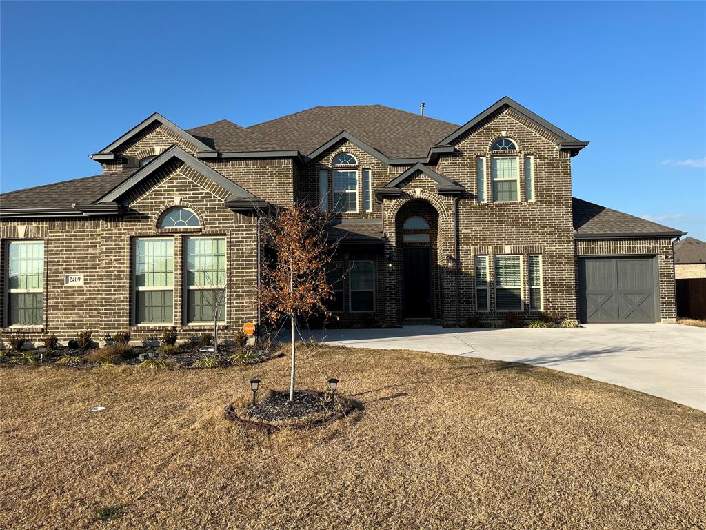 2409 Park Oaks Drive Midlothian, TX 76065 - Photo 2 of 18 a front view of a house with a yard