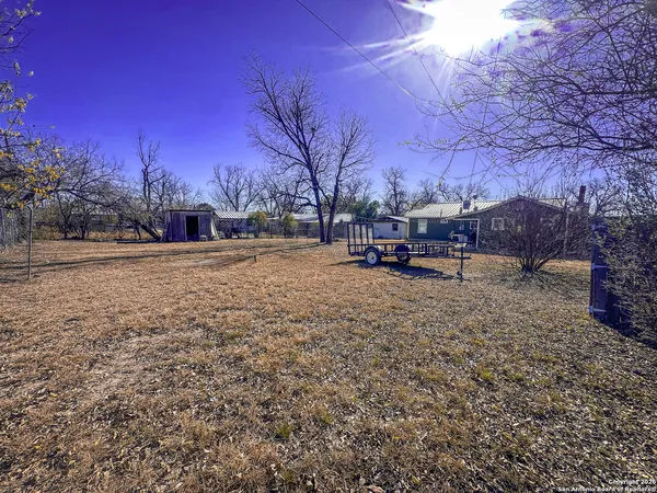 a view of a yard with a house in the background
