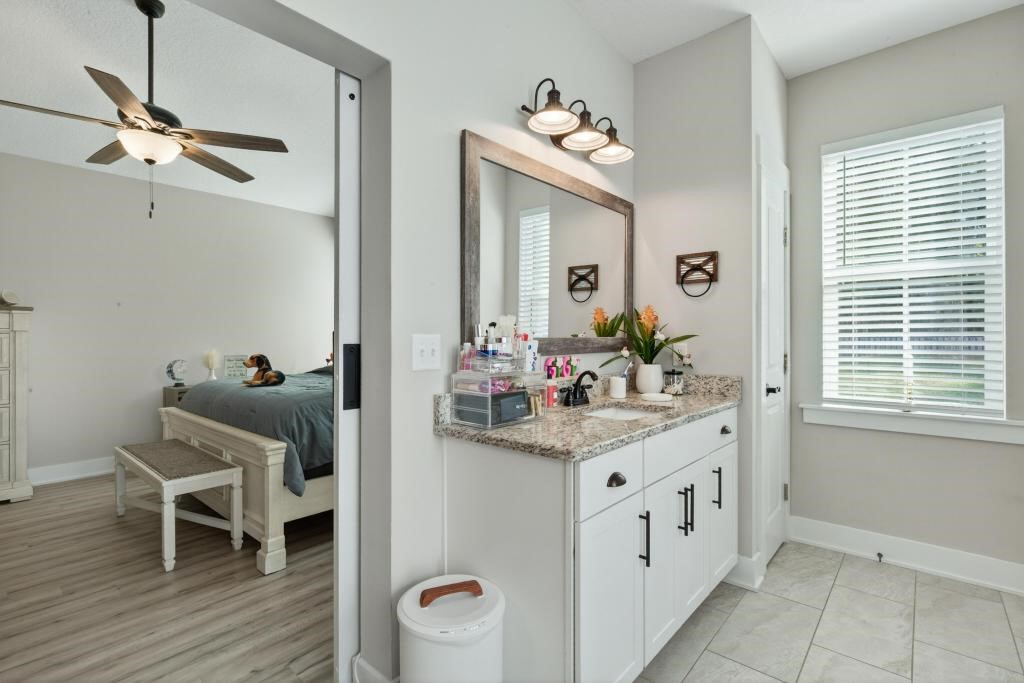 75774 Edwards Road Yulee, FL 32097 - Photo 45 of 70 a hallway with a mirror and furniture