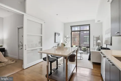 a room with a table chairs and entryway
