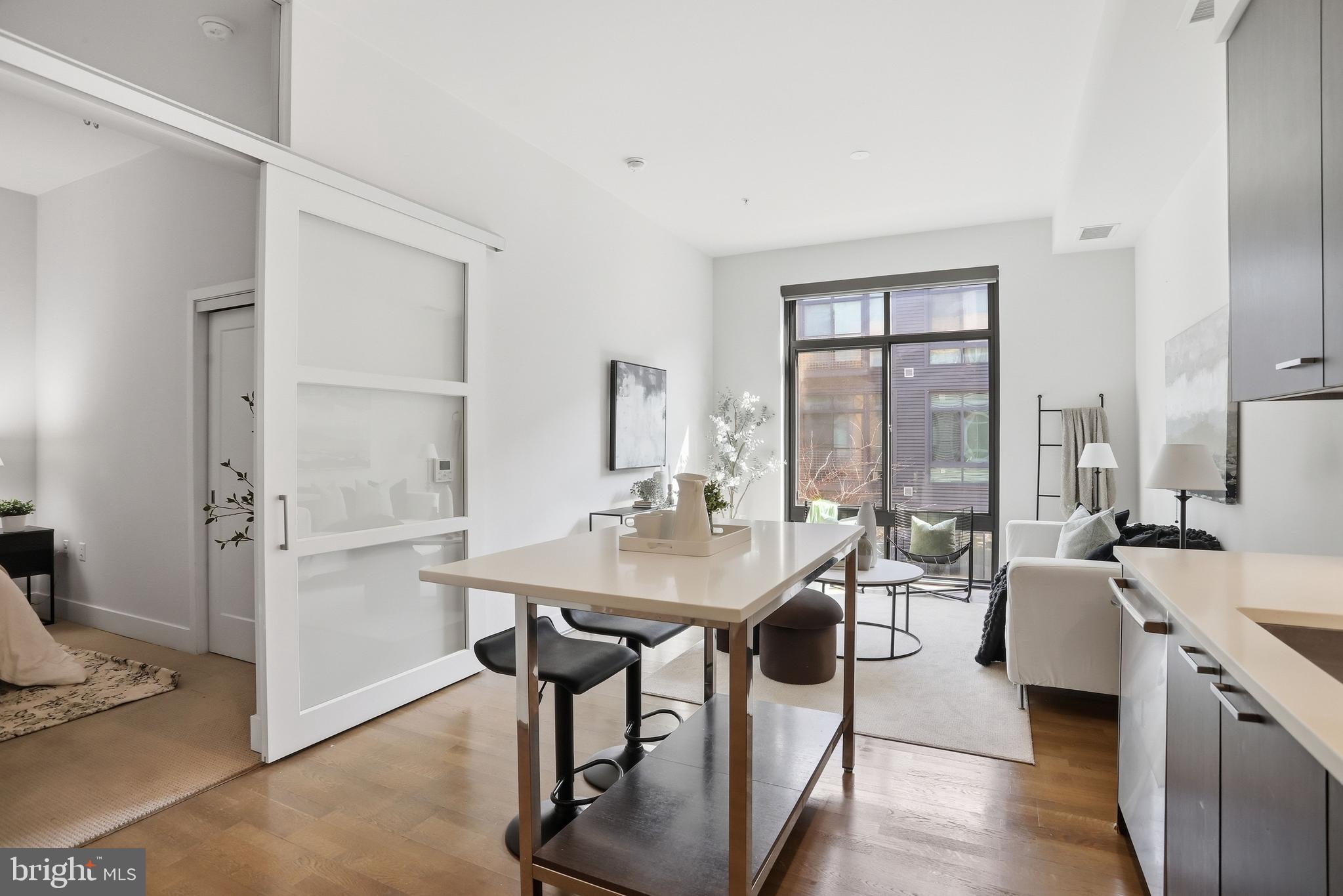 a room with a table chairs and entryway