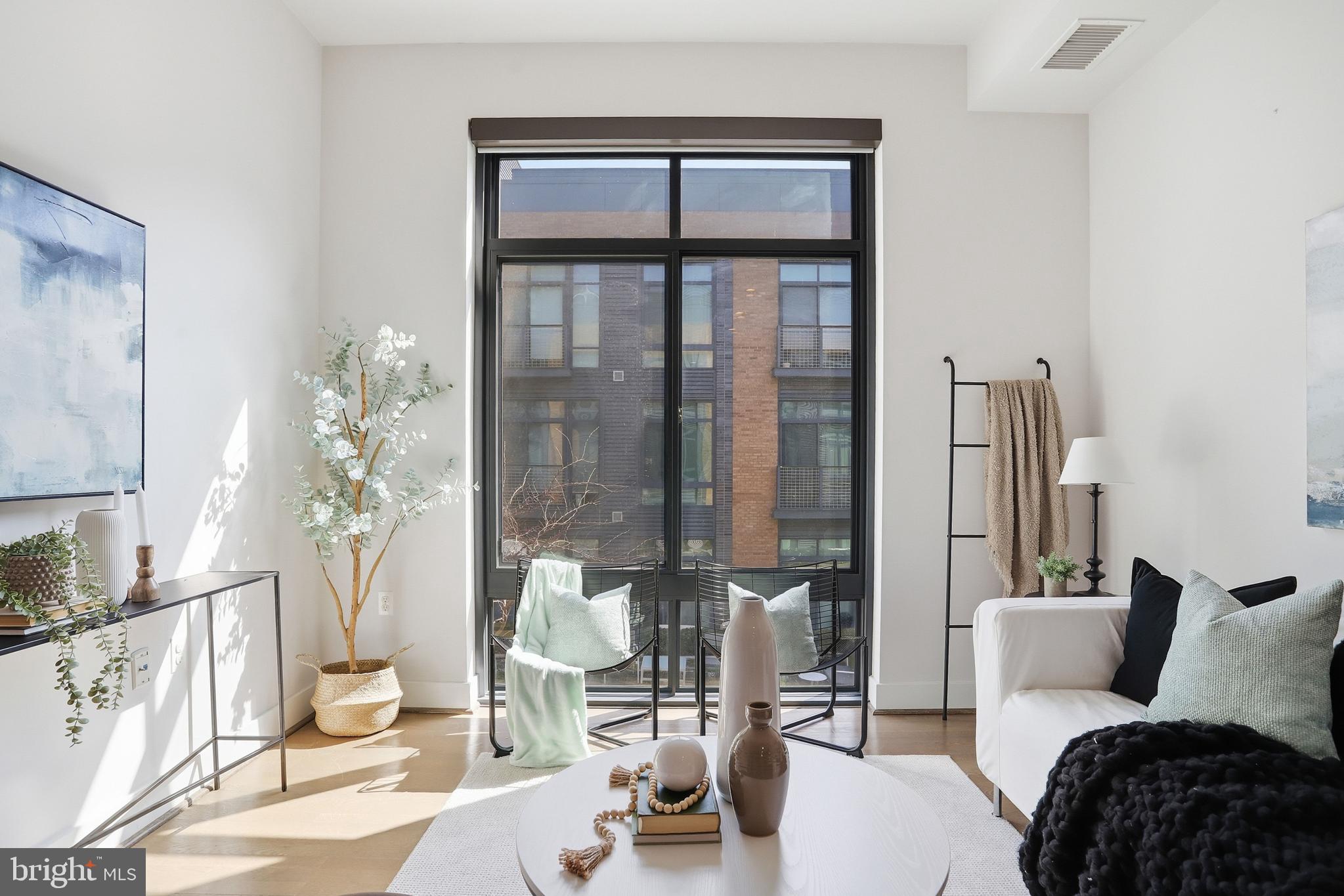 525 Water Street Southwest, Unit 311 Washington, DC 20024 - Photo 15 of 53 a living room with furniture and a large window