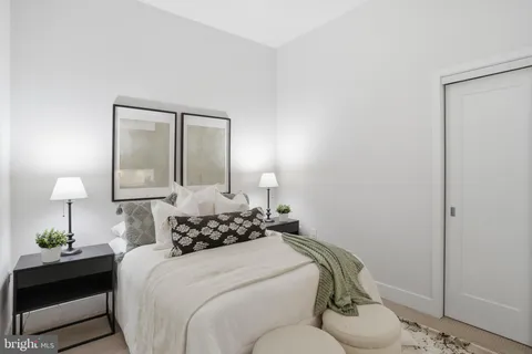 a bedroom with a bed and a lamp