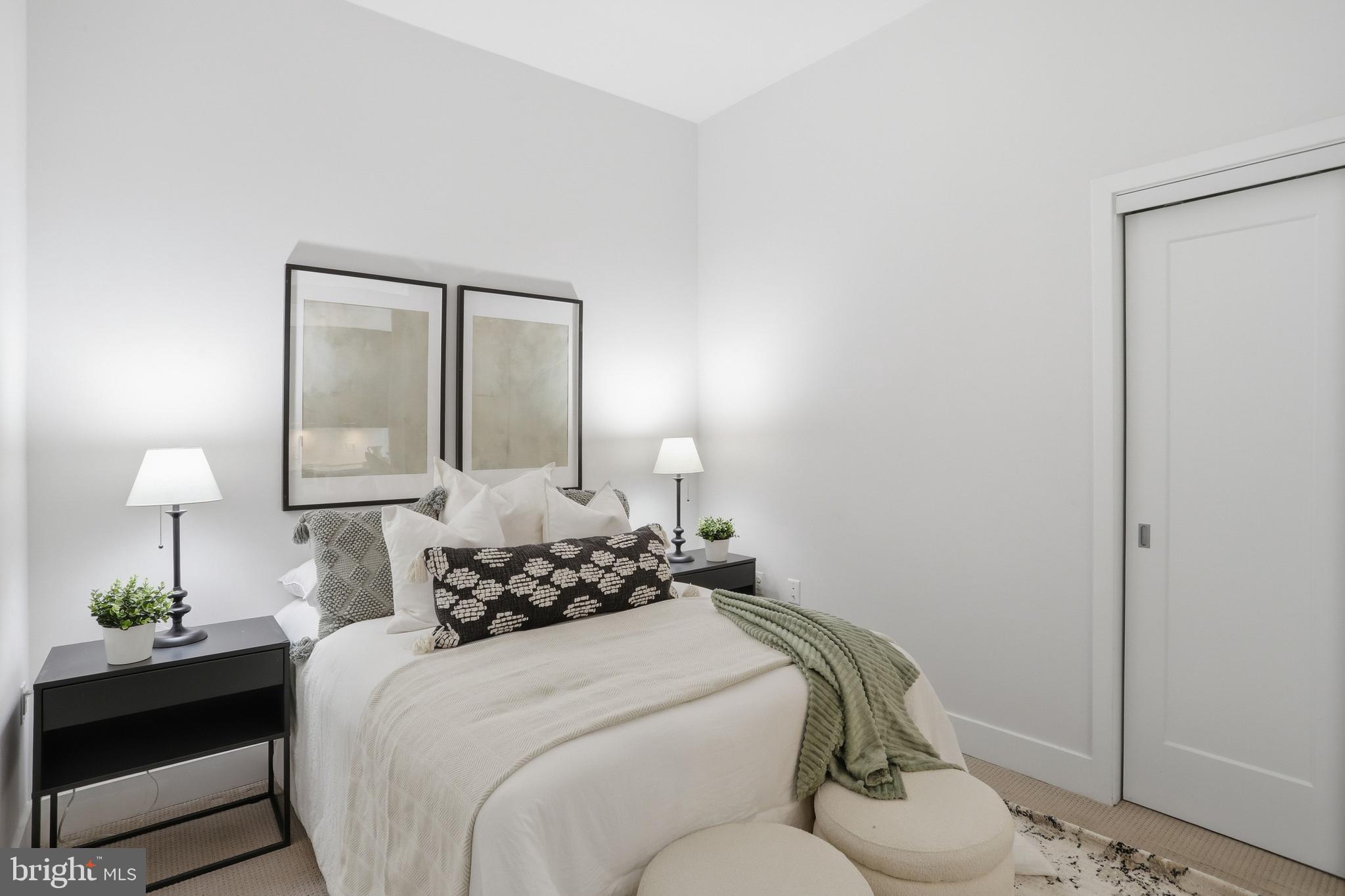 525 Water Street Southwest, Unit 311 Washington, DC 20024 - Photo 18 of 53 a bedroom with a bed and a lamp