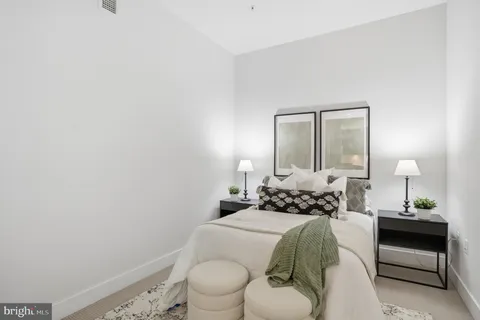 a bedroom with a bed and a mirror