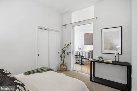 a bedroom with a bed and a mirror