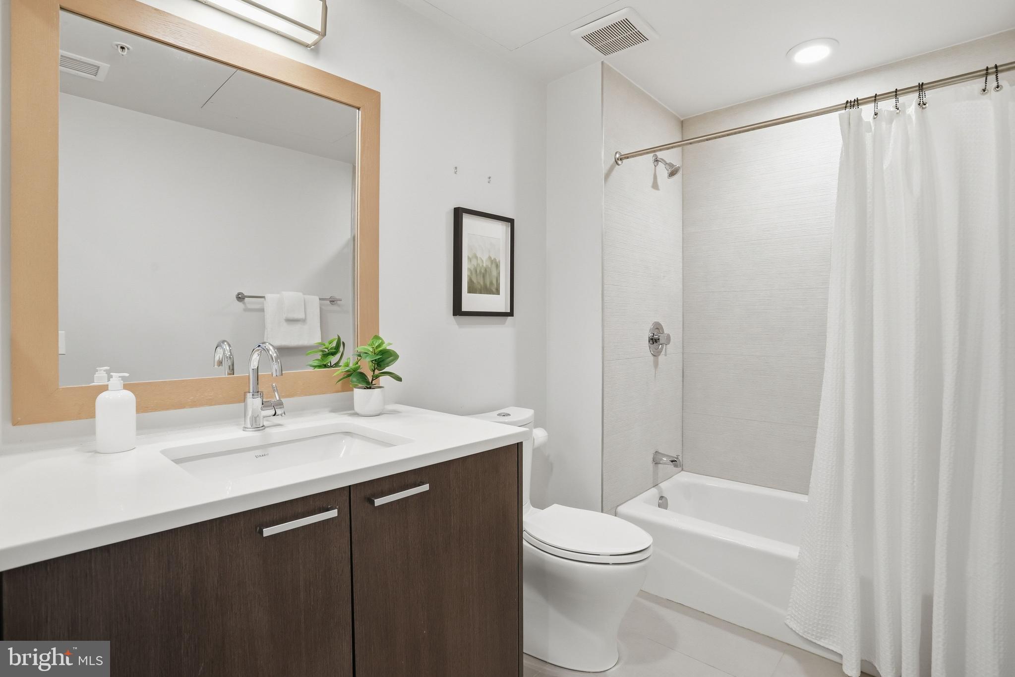 525 Water Street Southwest, Unit 311 Washington, DC 20024 - Photo 22 of 53 a bathroom with a sink a toilet and shower