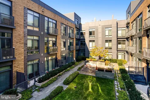 a view of a house with swimming pool and sitting area