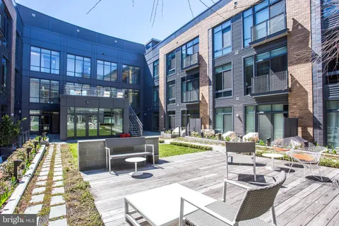 a view of a street with a large trees