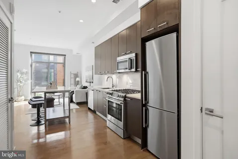 a kitchen with stainless steel appliances a refrigerator stove microwave and sink