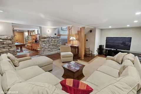 a living room with a table tennis table and a couch