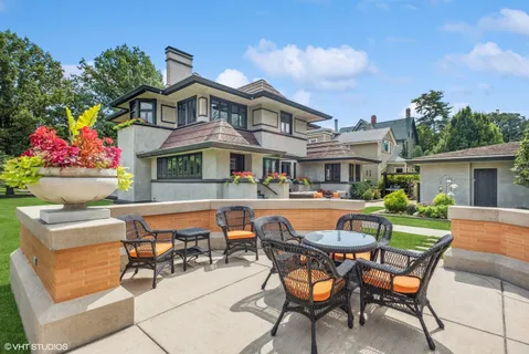 a view of a house with a yard porch and sitting area