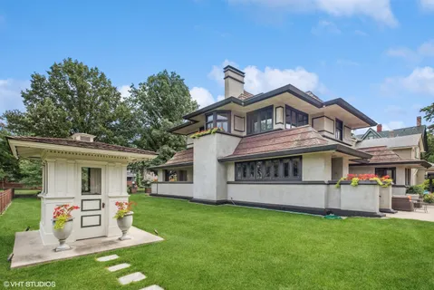 a front view of a house with garden and porch