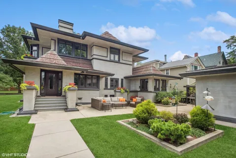 a front view of a house with a garden