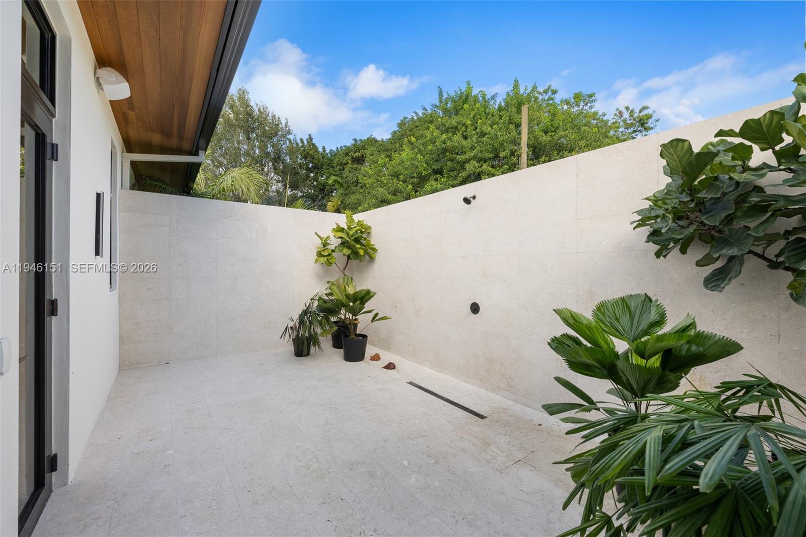 7725 Southwest 114th Street Pinecrest, FL 33156 - Photo 55 of 94 Exterior Shower & Tanning Area with Privacy Wall located in Primary Bedroom