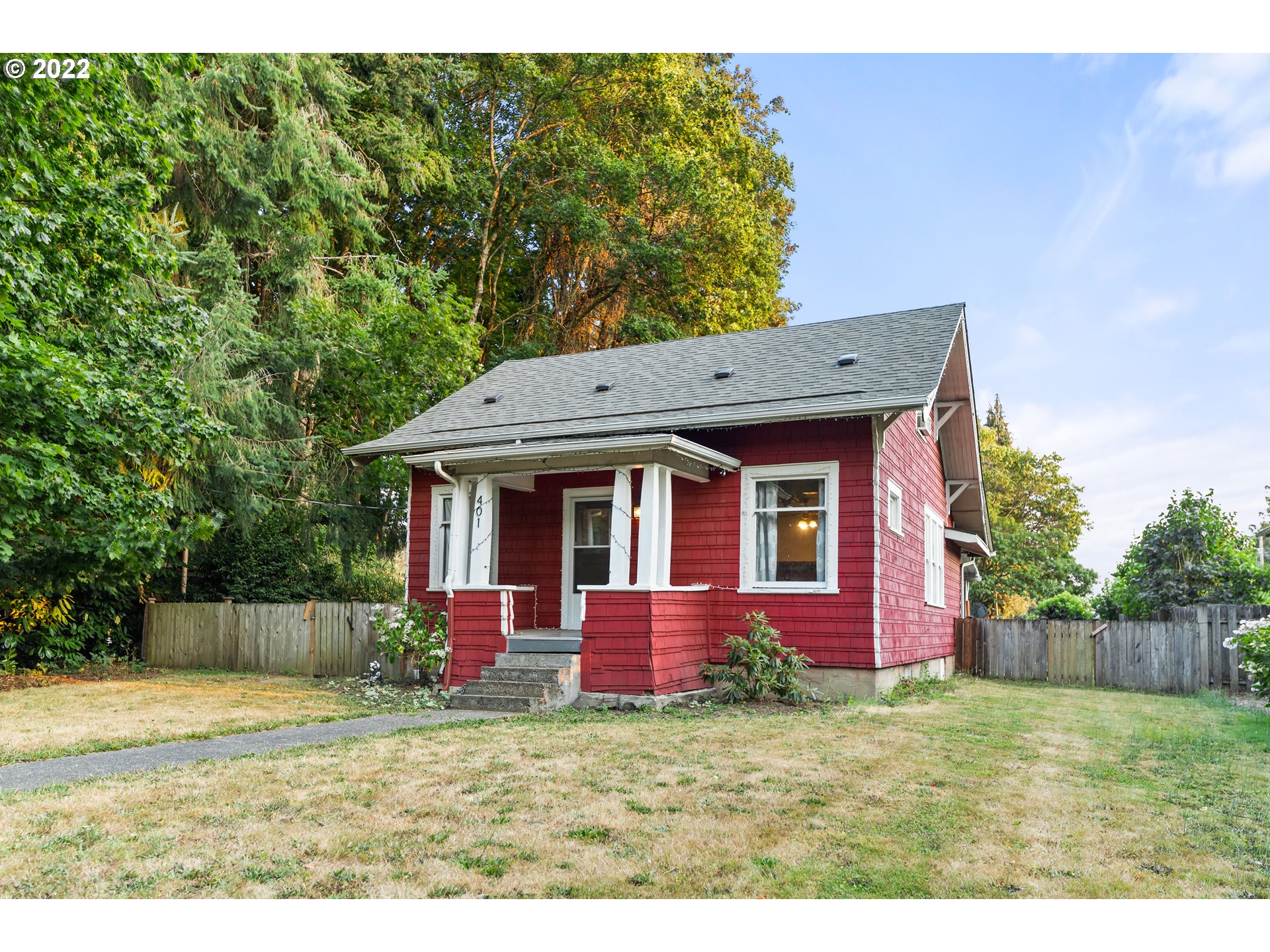 401 Maple Street Ridgefield, WA 98642 - Photo 3 of 31 a view of a house with a yard potted plants and large tree