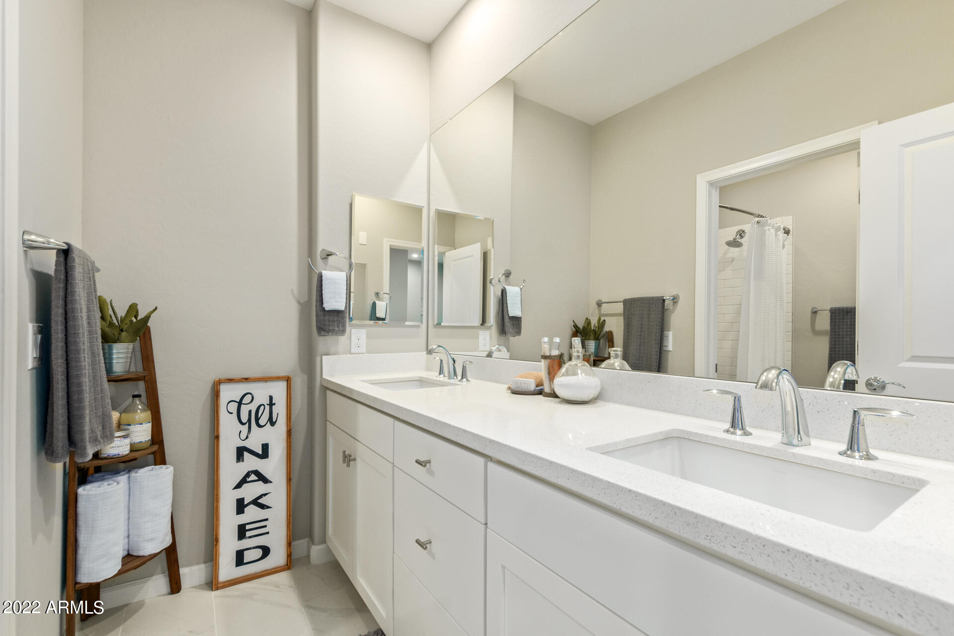 3935 East Rough Rider Road, Unit 1289 Phoenix, AZ 85050 - Photo 15 of 60 a bathroom with a double vanity sink and a mirror