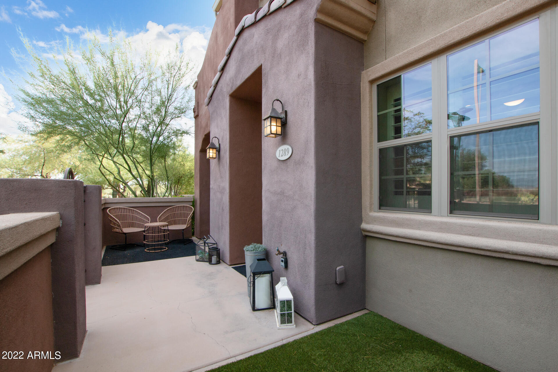 3935 East Rough Rider Road, Unit 1289 Phoenix, AZ 85050 - Photo 24 of 60 a backyard of a house with barbeque oven and outdoor seating